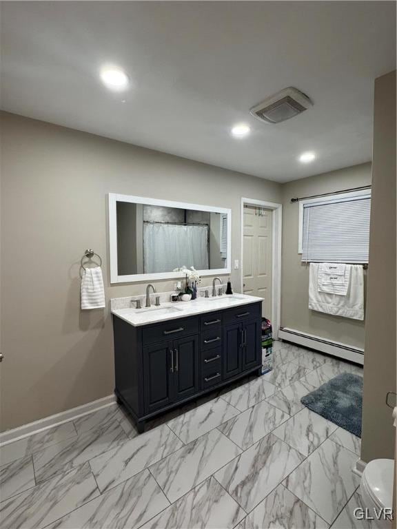 bathroom with a baseboard radiator, toilet, and vanity