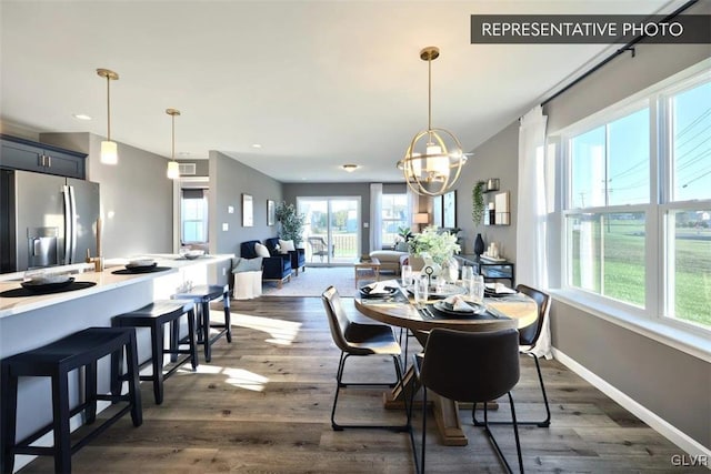 dining area featuring dark hardwood / wood-style flooring and a notable chandelier