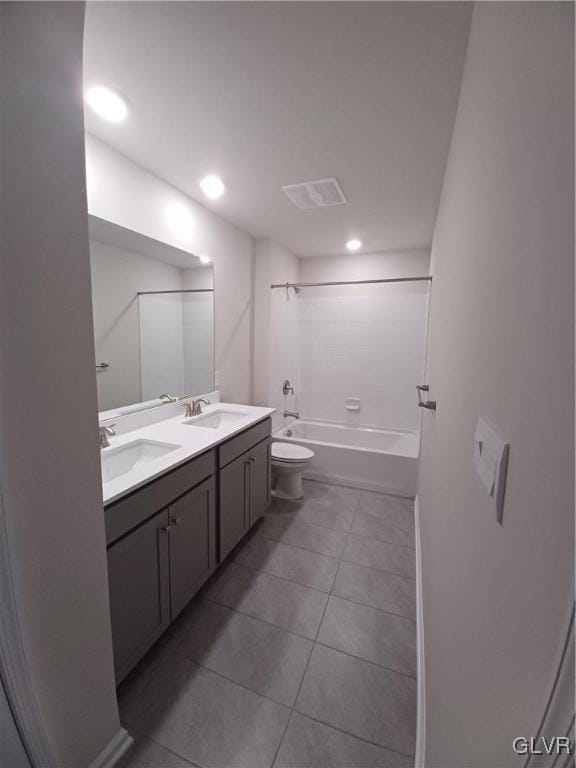 full bathroom featuring toilet, vanity, tile patterned floors, and  shower combination