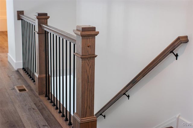 staircase featuring wood-type flooring