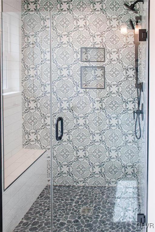 bathroom with a shower with shower door