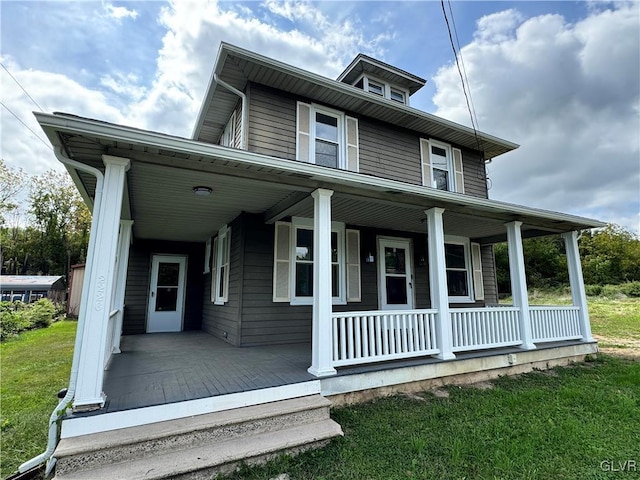 view of front facade featuring covered porch and a front yard