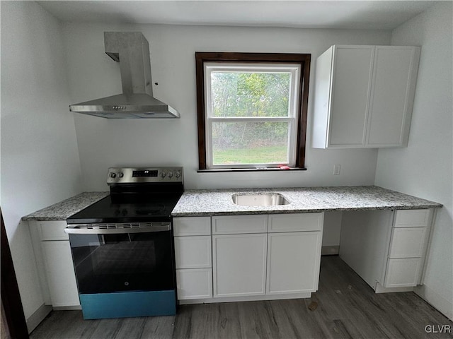 kitchen with white cabinets, exhaust hood, dark hardwood / wood-style flooring, and stainless steel range with electric cooktop