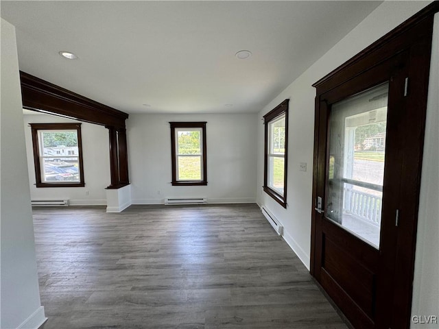 interior space with a baseboard radiator and dark hardwood / wood-style flooring