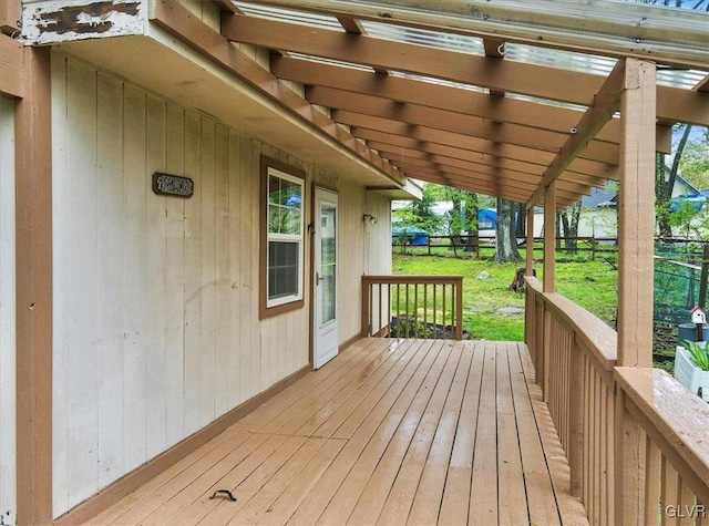 wooden terrace featuring a lawn