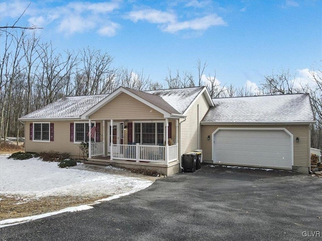 ranch-style house with a garage and covered porch