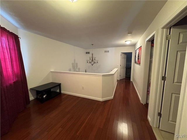 interior space featuring dark hardwood / wood-style flooring, hanging light fixtures, and a notable chandelier