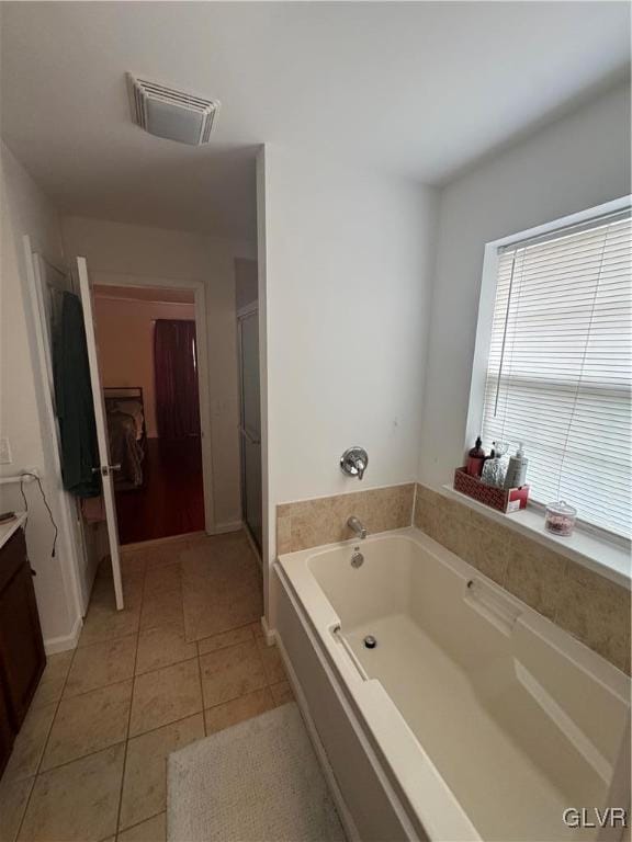 bathroom featuring separate shower and tub, vanity, and tile patterned floors