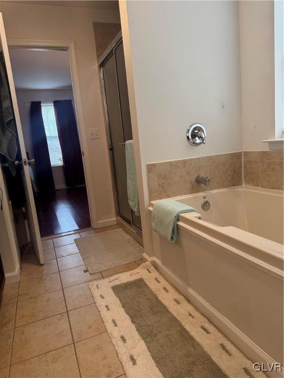 bathroom featuring tile patterned flooring and plus walk in shower