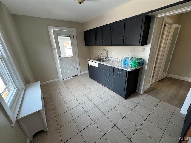 kitchen with light tile patterned floors and sink