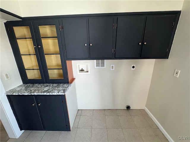 laundry area featuring hookup for a washing machine, cabinets, electric dryer hookup, and light tile patterned flooring