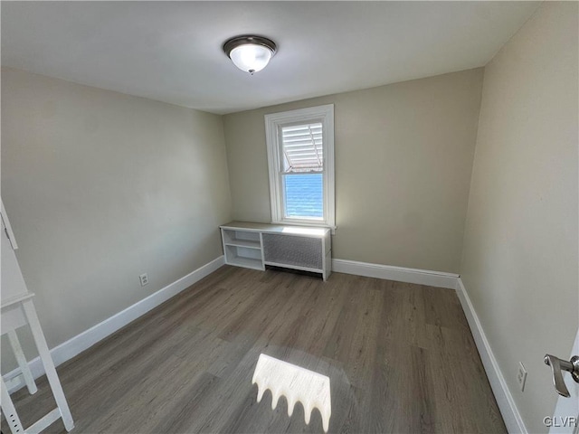 unfurnished room featuring hardwood / wood-style flooring