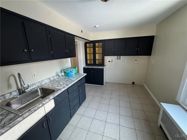 kitchen featuring light tile patterned floors and sink