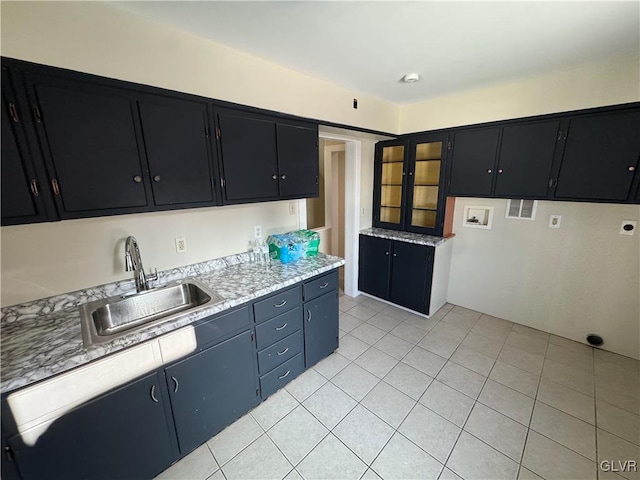 kitchen featuring sink and light tile patterned floors