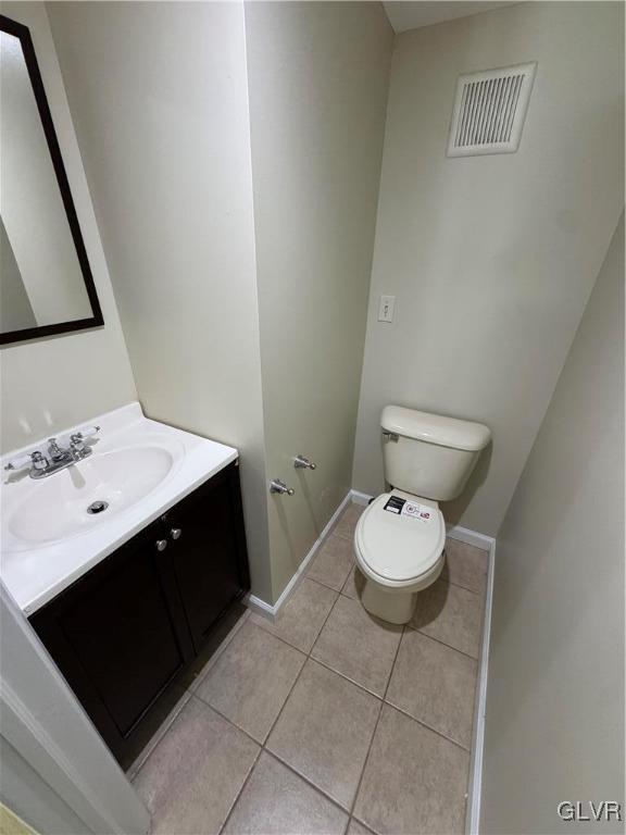 bathroom featuring tile patterned floors, toilet, and vanity