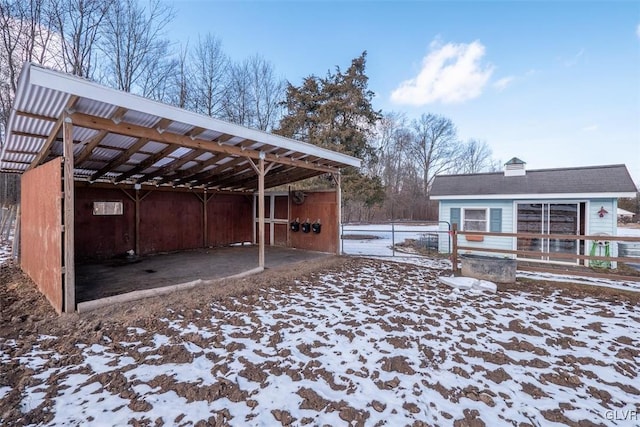 yard covered in snow featuring an outbuilding