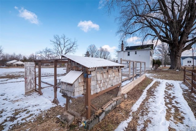 snowy yard with an outdoor structure