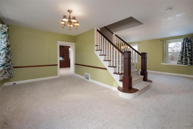 stairway featuring carpet flooring and a notable chandelier