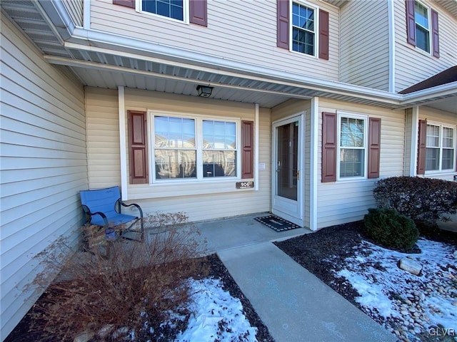 view of snow covered property entrance