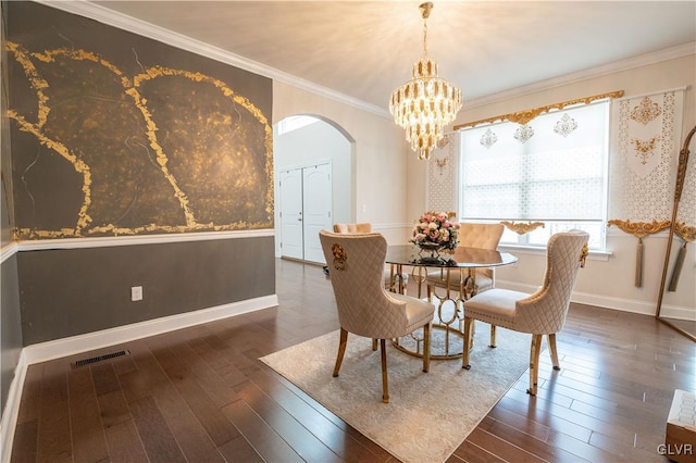 dining space featuring a chandelier, crown molding, and dark hardwood / wood-style floors