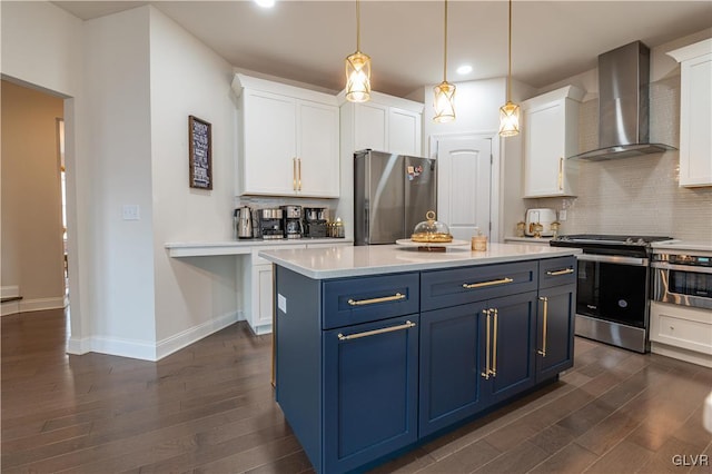 kitchen with blue cabinetry, appliances with stainless steel finishes, wall chimney exhaust hood, and white cabinetry