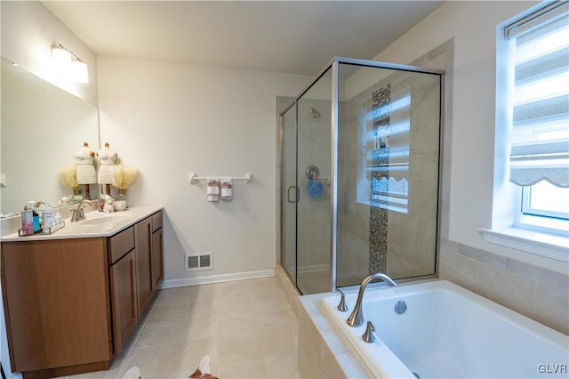 bathroom featuring plus walk in shower, tile patterned floors, and vanity