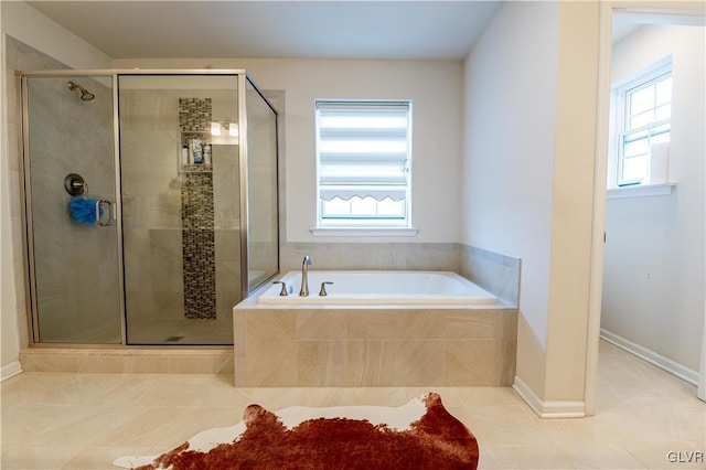 bathroom with tile patterned flooring and shower with separate bathtub