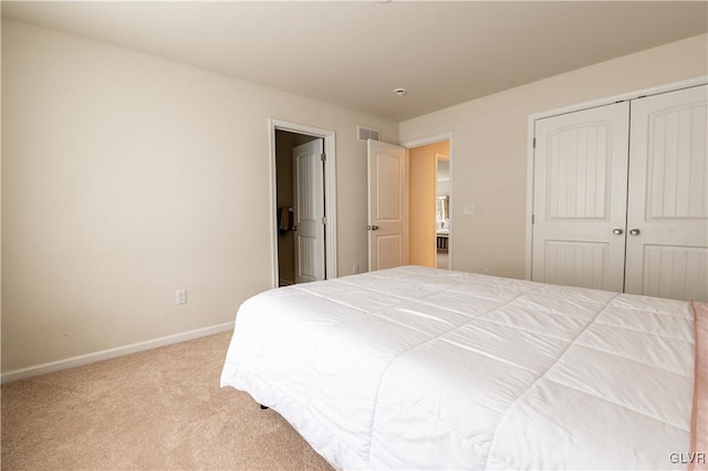 bedroom with light colored carpet and a closet