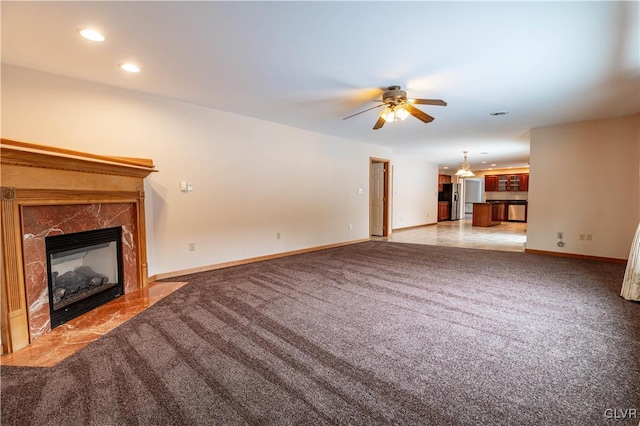 unfurnished living room featuring ceiling fan and light colored carpet