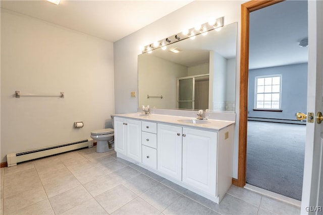 bathroom with a baseboard heating unit, toilet, an enclosed shower, and vanity