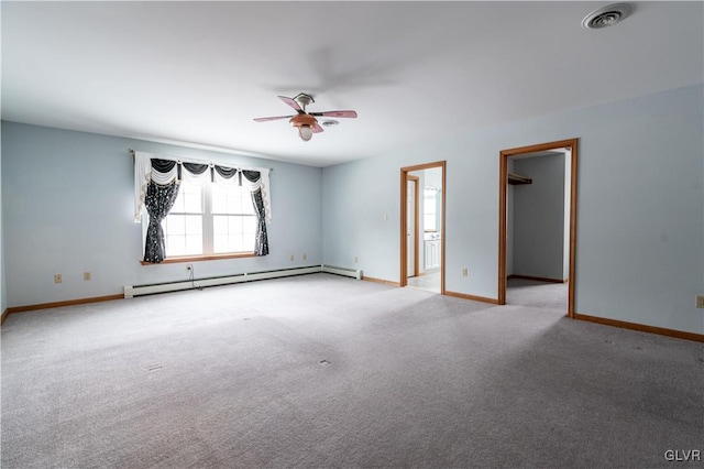 empty room featuring baseboard heating, light colored carpet, and ceiling fan