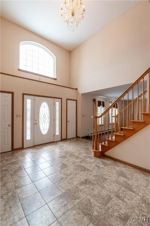 foyer with a towering ceiling and an inviting chandelier