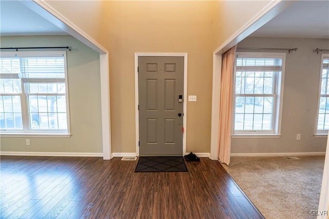 entrance foyer with dark wood-type flooring and plenty of natural light