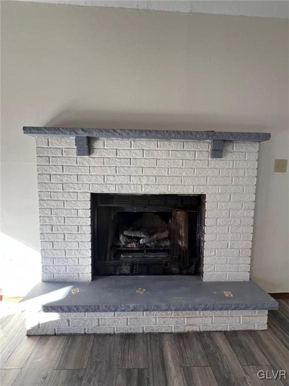 details featuring a brick fireplace and hardwood / wood-style flooring