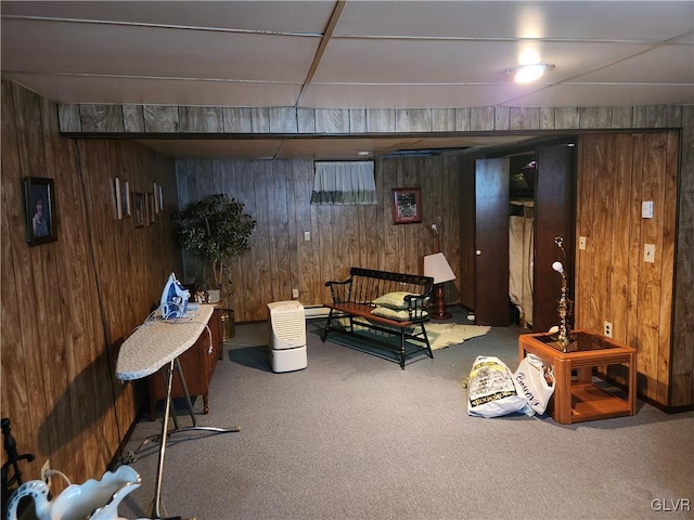 basement featuring carpet floors and wooden walls