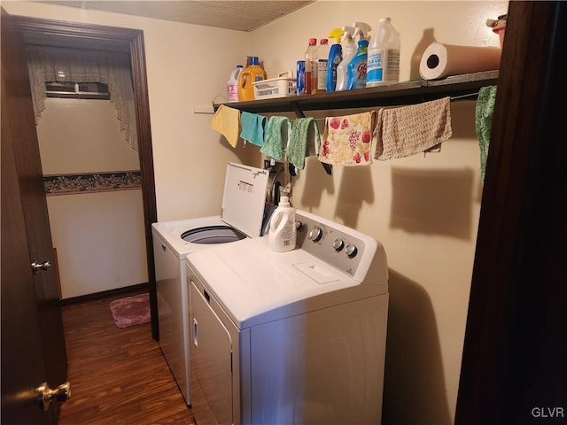 laundry room with washer and dryer and dark hardwood / wood-style flooring