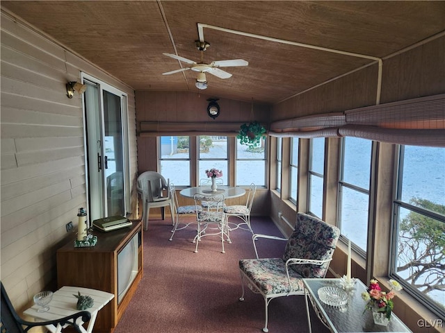 sunroom featuring ceiling fan, vaulted ceiling, wood ceiling, and a wealth of natural light