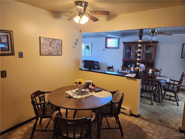 dining room with baseboard heating, carpet floors, and ceiling fan