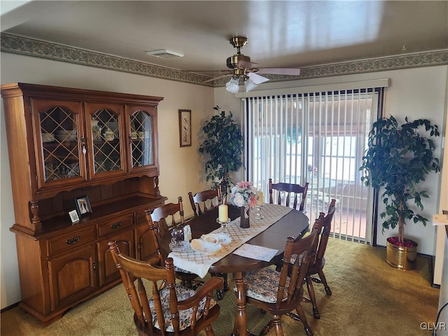 carpeted dining area featuring ceiling fan