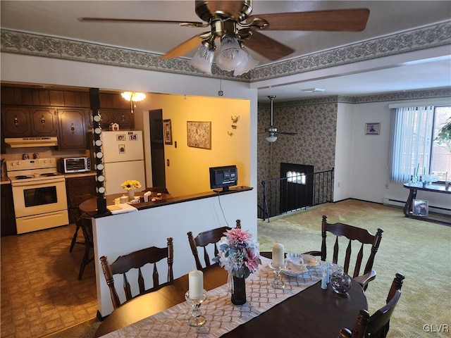 dining room with ceiling fan and carpet floors