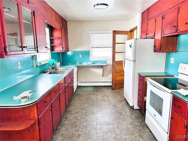 kitchen featuring a baseboard heating unit, sink, and white appliances