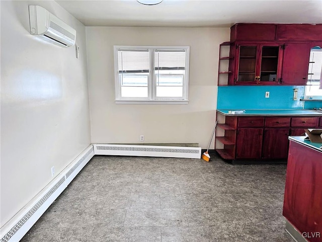 kitchen featuring a baseboard heating unit and an AC wall unit