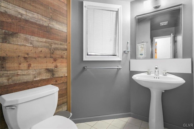 bathroom with toilet and tile patterned floors