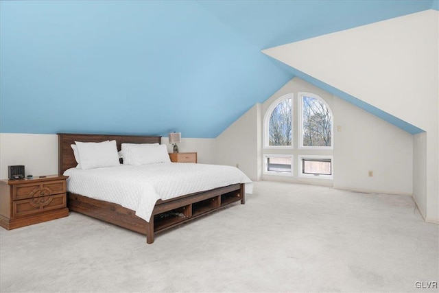 bedroom with light carpet and vaulted ceiling