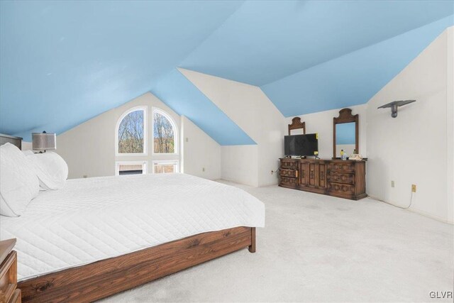 bedroom featuring light colored carpet and vaulted ceiling