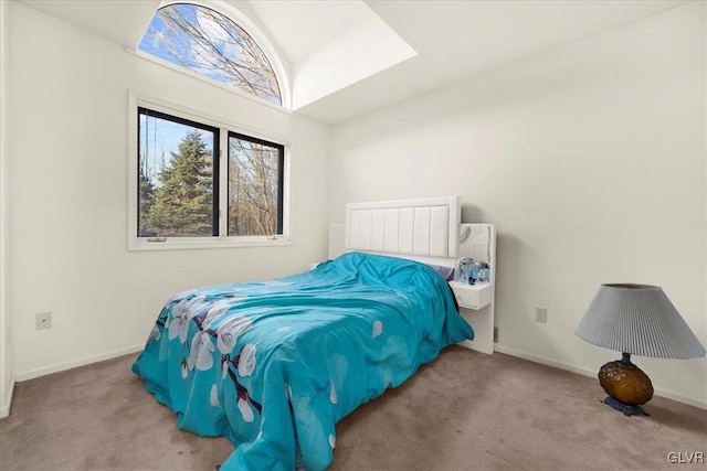 bedroom with lofted ceiling, light colored carpet, and baseboards