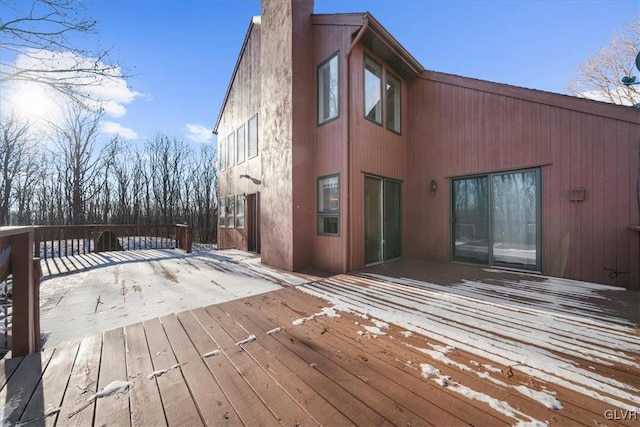 exterior space with a deck and a chimney