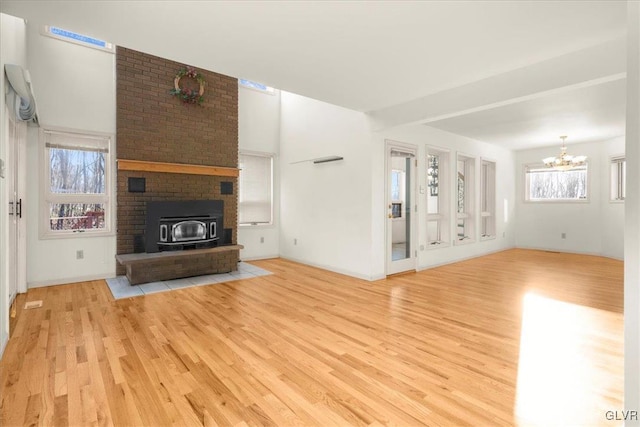 unfurnished living room featuring light hardwood / wood-style floors and a notable chandelier