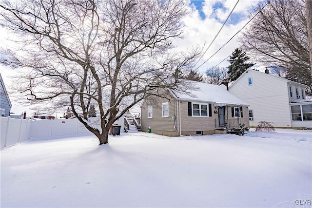 view of snow covered back of property