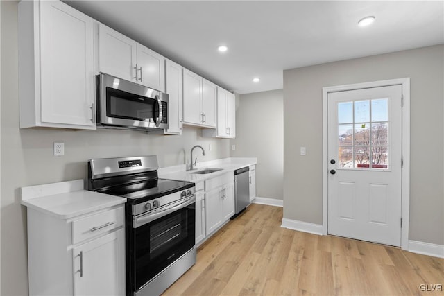 kitchen with white cabinets, sink, and stainless steel appliances